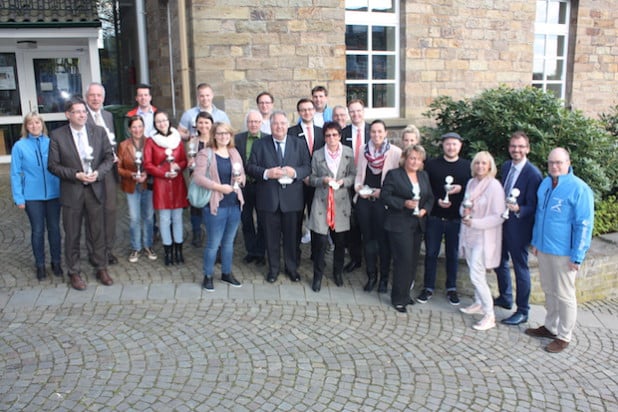 Das Organisationsteam präsentierte gemeinsam mit Vertretern der Sponsoren und Unterstützern die Pokale: (v.l.) Andrea Sax (Lindlar läuft), Hendrik Höller, Michael Dlusniewski (beide Autohaus Heitmeyer), Ingrid Brück, Peter Wolf, Nicole Brück (alle DB forma GmbH), Renate Groneuer (Reloga), Marcel Hoenerbach (Neuland), Anika Buchheim (Lang AG), Joachim Stölzel (Deutschorden Pfarrer-Braun-Haus), Christoph Pinner (Siebei-Druck), Frank Peffekoven (Quirrenbach), Samuel Fragen (Kreissparkasse), Sebastian Hinterding, Bodo Lorsch (beide Lindlar läuft), Elke und Tanja Friedrich (Industriedruck Friedrich), Rafael Niederung (Kreissparkasse), Eva Claudi (Lang AG), Tanja Sommerauer (S+C), Marius Lubetzki (Neuland), Birgit Pauquet (Holz Richter), Lars Niemczewski (S+C) und Moderator Armin Brückmann. (Quelle: Lindlar läuft)